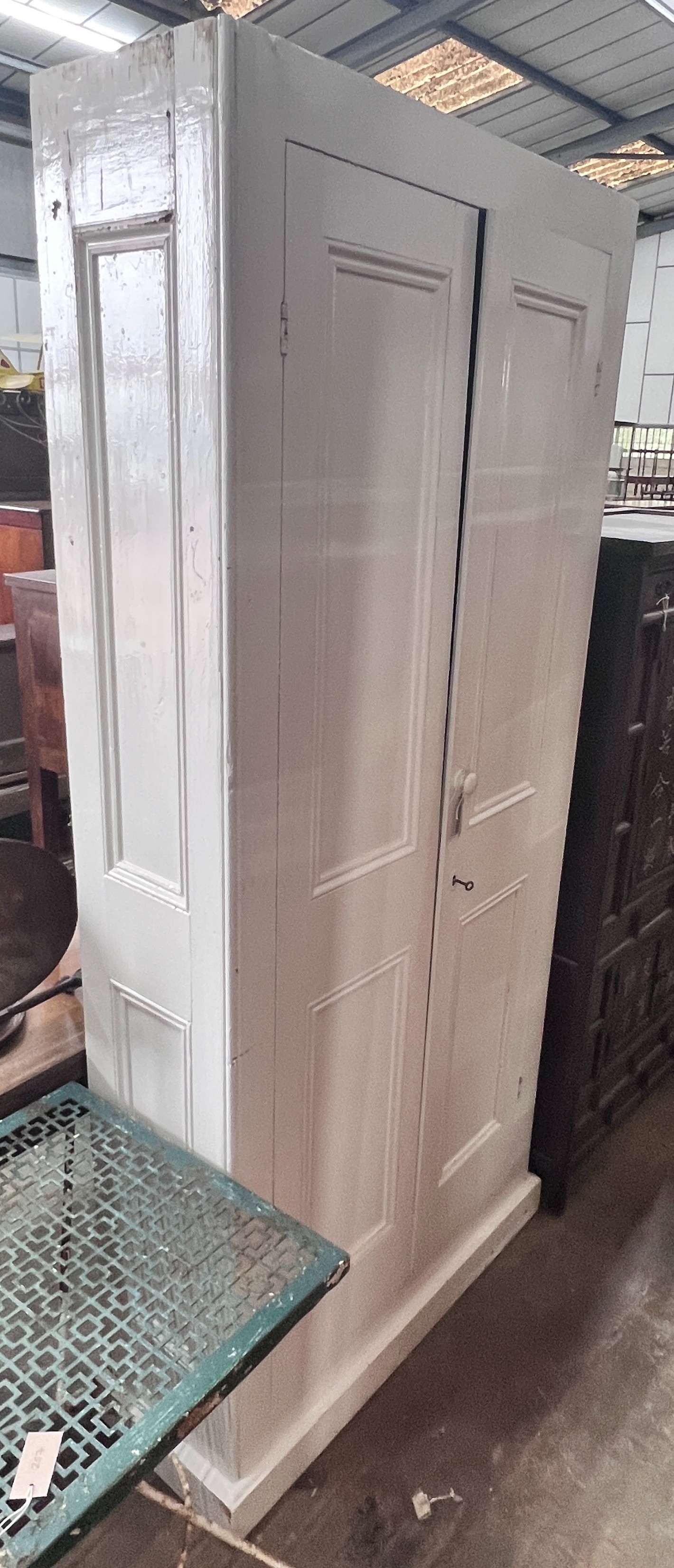 A white painted pine housekeeper's cupboard, width 99cm, height 210cm *Please note the sale commences at 9am.